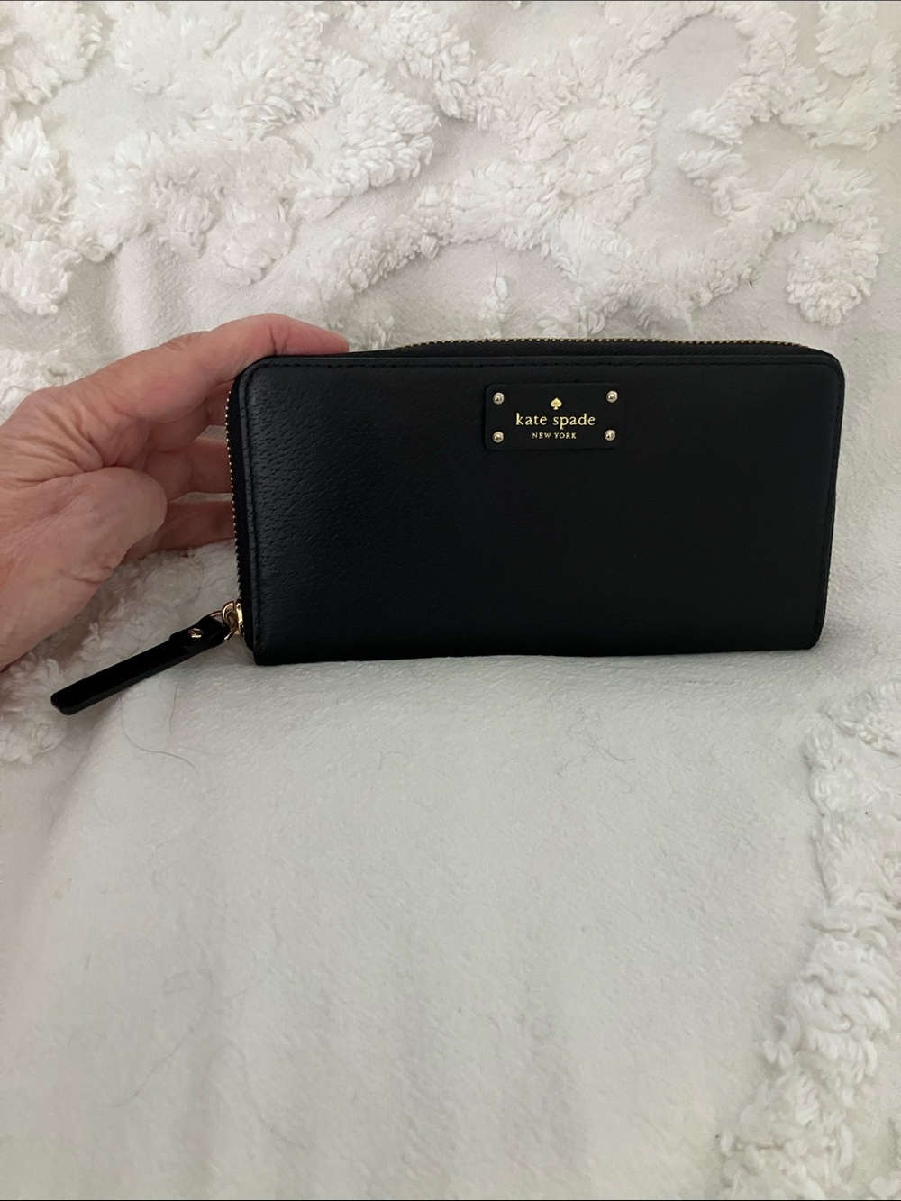 kate spade black leather zip-around wallet with gold plaque
